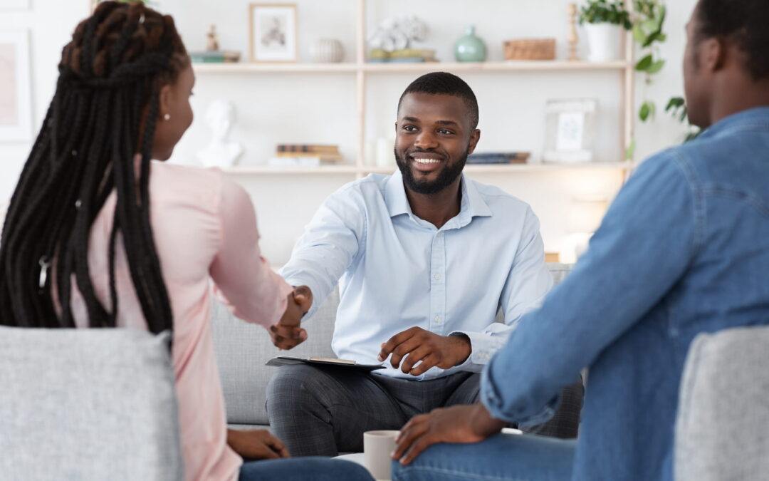 family-counselor-shaking-hands-with-happy-couple