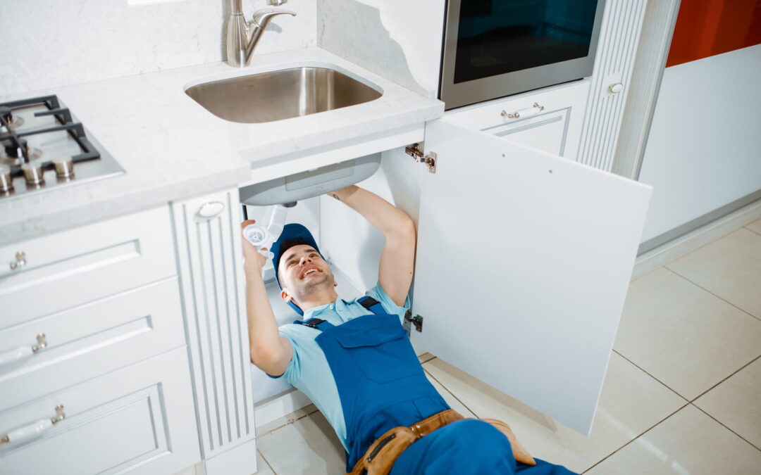 Plumber fixing a leaky pipe